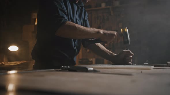 Unrecognizable Craftsman Working with Skin Material on Workplace Table at Workshop