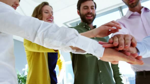 Business executives doing hand stack on table