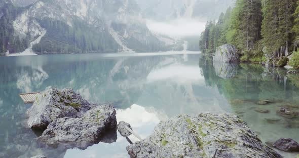 Aerial Drone Flight Establisher Over Lake with Clouds and Forest