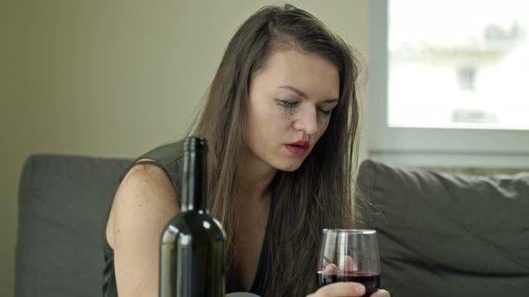 Depressed Young Woman Crying a Victim of Domestic Violence or Abuse Tries to Relieve Suffering with