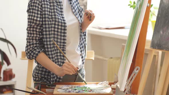 Pleasant Blond Woman Is Working in the Art Studio