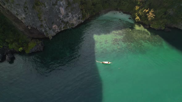 aerial top down view circling a thai longtail boat on a tour of the islands in Krabi Thailand on a s