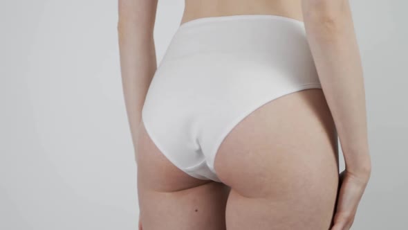 Woman Compressing the Skin of the Buttocks and Sides Checking for Cellulite and Excess Subcutaneous