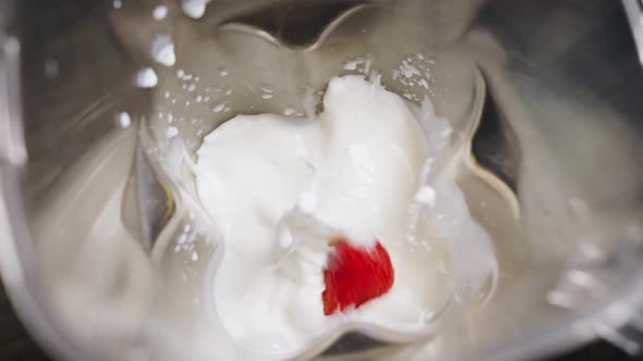 Housewife Throws Fresh Berries Into Milk in Bowl to Mix