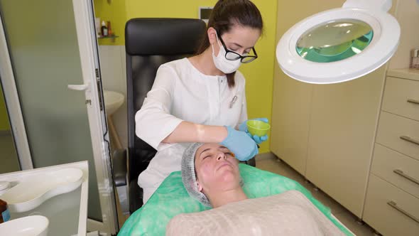 Woman Relaxing During Citric Acid Peeling Procedure in Beauty Salon