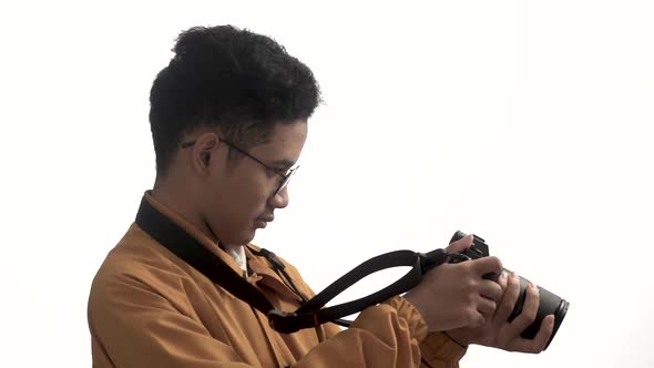 hight key video of asian man with his professional camera