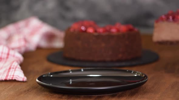 Delicious Piece Of Chocolate Cheesecake with cherry.	