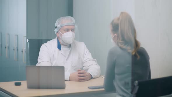 Modern Private Clinic Young Female at a Doctor's Appointment Adult Man Doctor and a Young Woman in