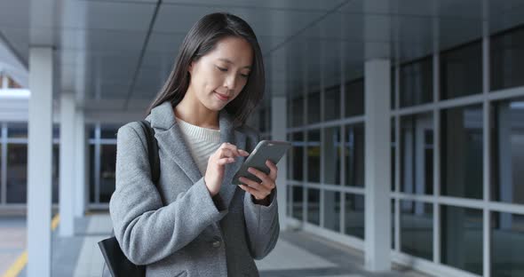 Woman use of mobile phone in city