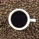 A Cup Of Black Coffee On A Background Of Rotating Coffee Beans. - VideoHive Item for Sale