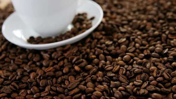 Cup of coffee with roasted beans