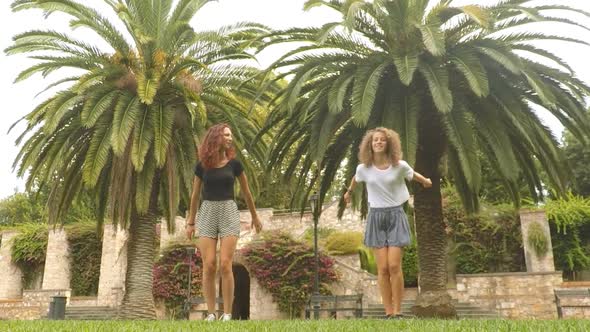 Slow-motion view of two girls jumping at park