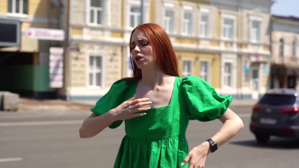 Portrait of Exhausted Young Woman Traveler Suffers From Heat Standing at City Street in Sunny Summer