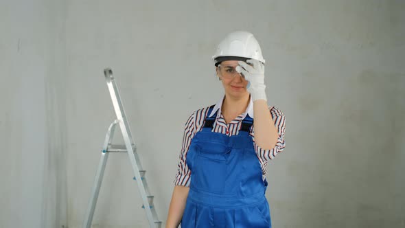 Female Worker with a Puncher in Hands Indoors