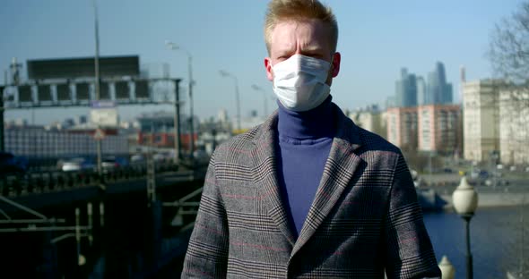 Alone City Dweller Is Walking on Street, Wearing Protective Mask on Face From Viruses