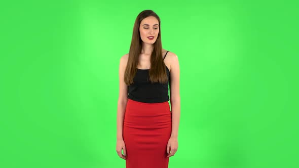 Girl Listens Carefully To Boring Information and Looks Around. Green Screen
