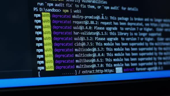 Developer looks at console output on a computer screen. Install JavaScript packages via npm