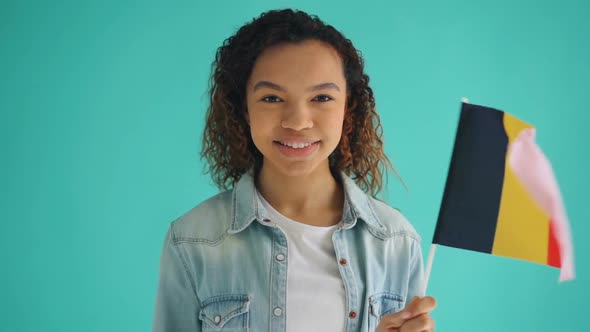 Slow Motion Portrait of African American Woman Waving Flag of Germany Smiling