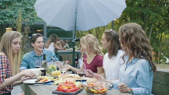 People Eating Healthy Food On Outdoor Party.