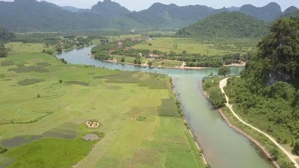 Tranquil River Runs Along Valley with Fields Aerial View