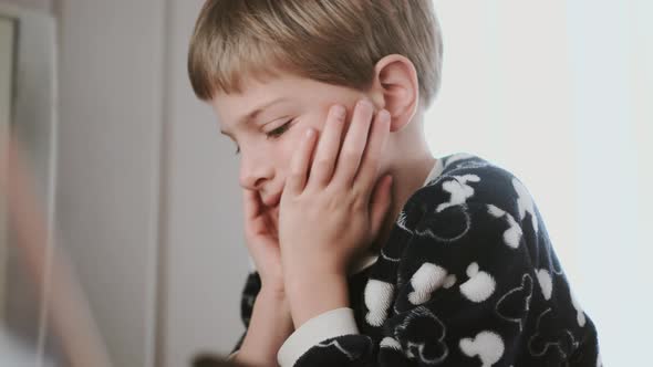 Portrait Of Boy With Blond Hair. Calm Boy With Conceived Facial Expression.