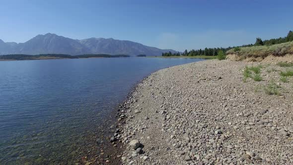 Camera flies low over a shore on Jackson Lake