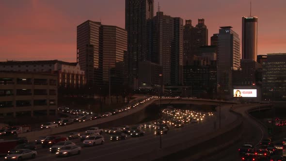 Static, medium wide, nighttime shot of the Atlanta Skyline with traffic below.