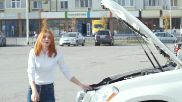 Young Stressed Woman Driver Near Broken Car with Popped Hood Having a Prbreakdown Problem with Her