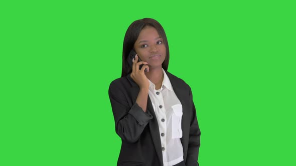Casual African American Businesswoman Talking on Phone on a Green Screen, Chroma Key.