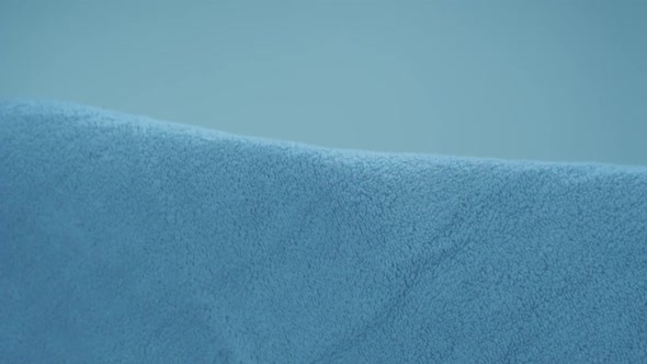 Rolling blue towel in midair, Slow Motion