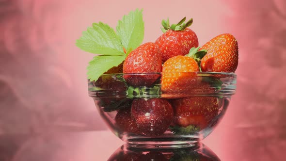 strawberries in glass transparent bowl rotating 