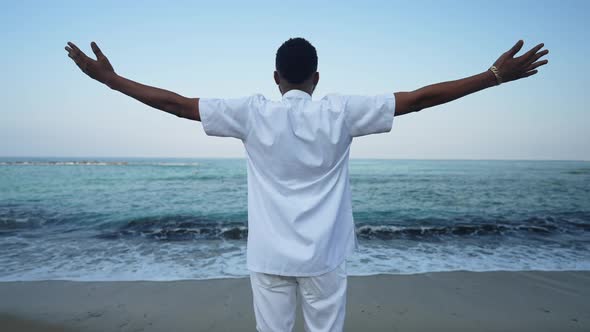 Excited African American Young Man Stretching Hands Admiring Beauty of Turquoise Azure Mediterranean