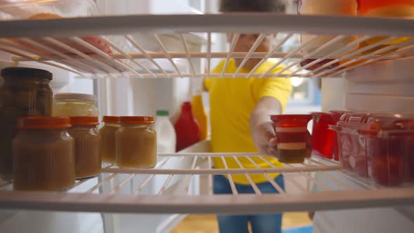 Happy African Kids Taking Yogurt and Jelly for Snack From Fridge