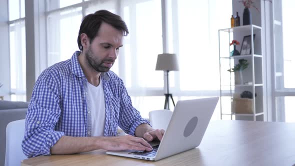 Man in Shock Wondering While Working on Laptop