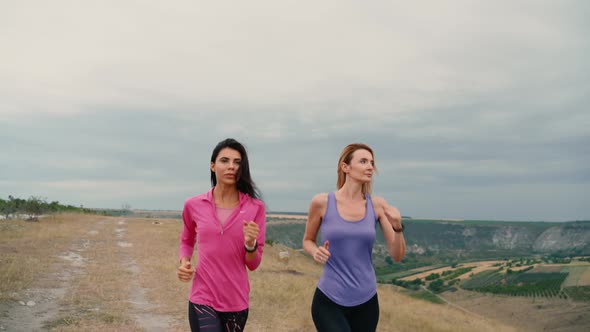 Two Young Women's Runner Training in Summer Park