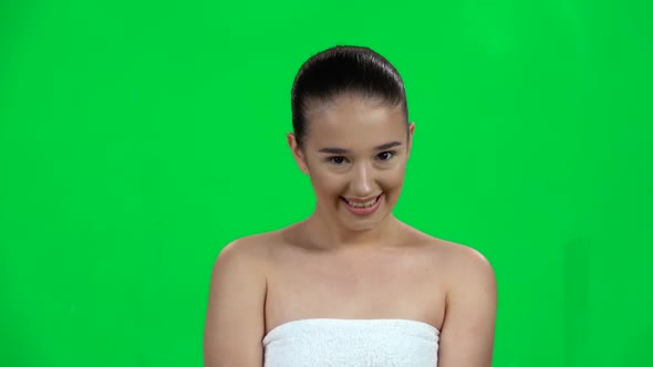 Beautiful Girl Shyly Smiles and Gently Touches the Skin. Green Screen. Slow Motion