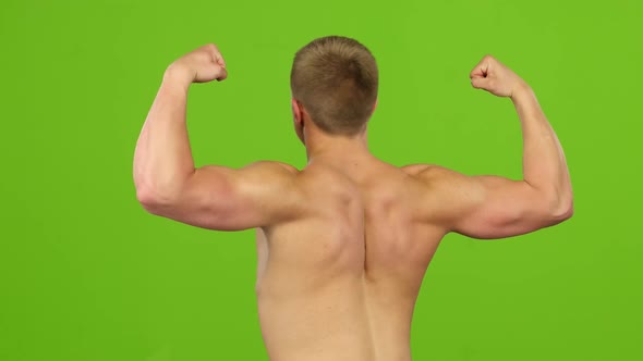 Man Strains Muscles and Shows Results, Back View. Green Screen