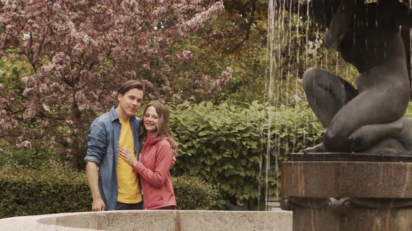 Young, happy, loving couple having date in the park. Relations, friendship and love concept.