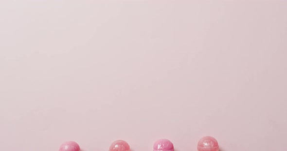 Video of pink lollipops on pink background