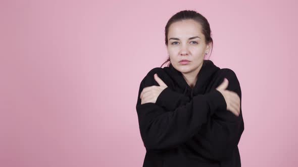 Caucasian Pretty Young Girl in Sweater Tries To Keep Warm and Rubs Her Hands