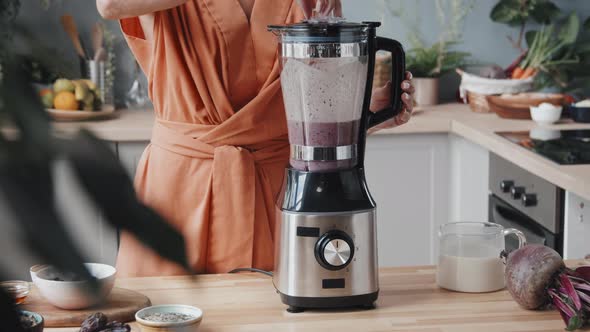 Healthy Woman Making Smoothie in Kitchen