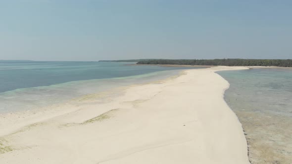Aerial: tropical beach island reef caribbean sea white sand bar Snake Island, Indonesia Maluku
