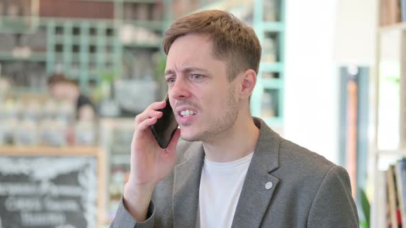 Portrait of Young Man Talking on Phone