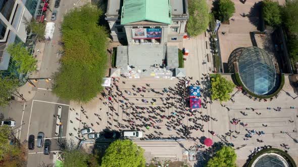 A Crowd of people protest, static drone overhead shot in Downtown Vancouver the capital city of Brit