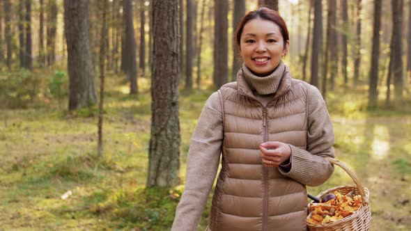 Woman with Mushrooms Showing Thumbs Up in Forest