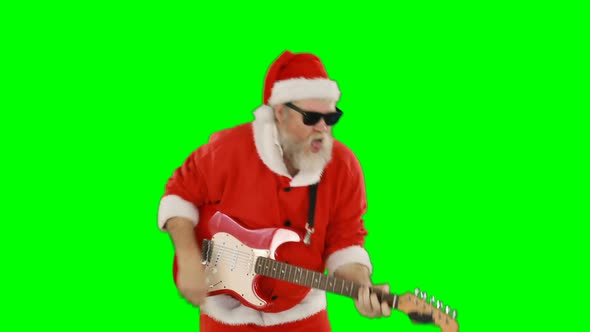 Santa claus singing a song and playing guitar