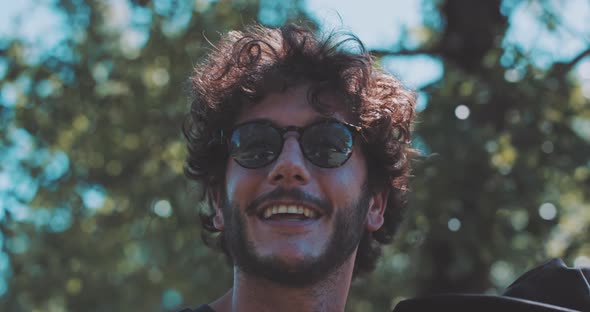 Young man with beard speaking and laughing with blonde girlfriends