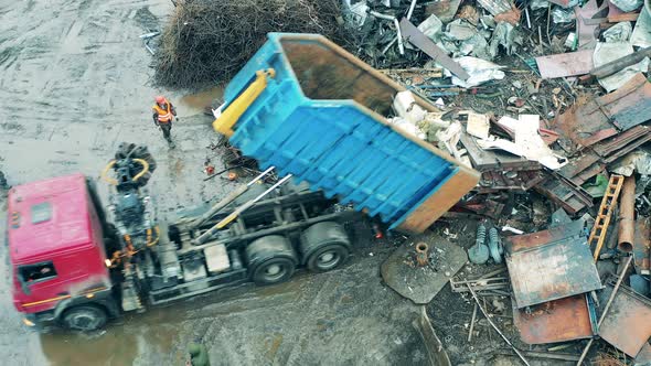 Truck is Unloading a Pile of Scrap Metal