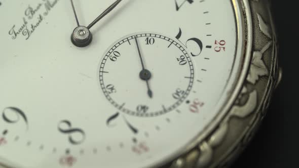 Running Second Hand on an Old Pocket Watch with a White Dial. Close Up