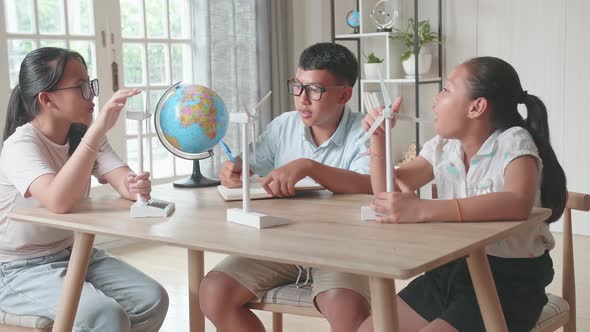 Kids Study About Ecology Problems With Wind Turbine Model And Globe At School. Renewable Energy